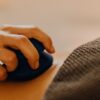 Hands applying relaxing massage therapy with hot stones in a calming spa environment.